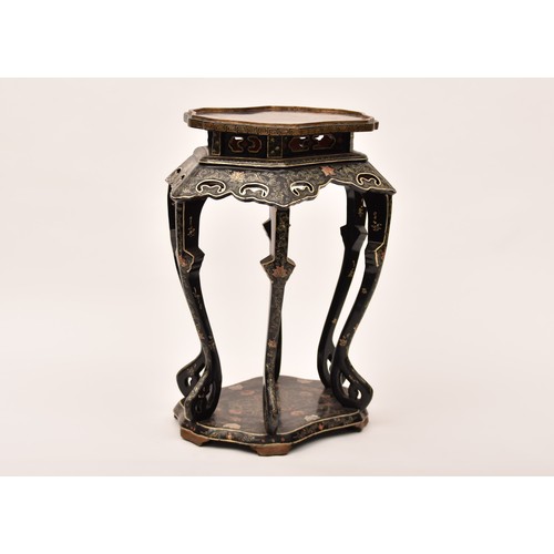 48 - A large Japanese black lacquer jardiniere stand, the top deorated with an extensive mountainous lans... 