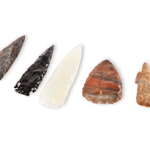 299 - A collection of seven spear heads of varying materials and colours, glass and stone carved and chipp... 