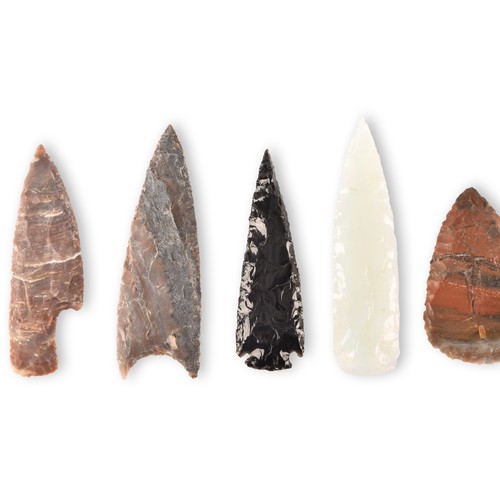 299 - A collection of seven spear heads of varying materials and colours, glass and stone carved and chipp... 