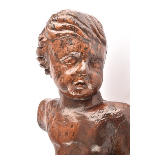 243 - A 19th century Italian carved fruit wood sculpture of a cherub, in tradition pose, with one leg rais... 