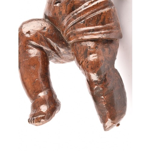 243 - A 19th century Italian carved fruit wood sculpture of a cherub, in tradition pose, with one leg rais... 