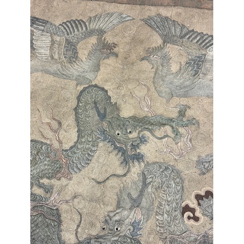 19 - A large antique Chinese silk needlework tapestry wall hanging, decorated with give dragons chasing a... 