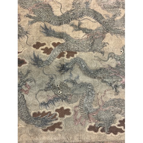 19 - A large antique Chinese silk needlework tapestry wall hanging, decorated with give dragons chasing a... 