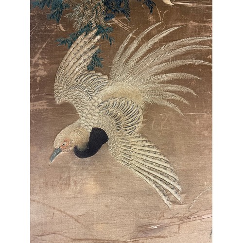 25 - A 19th century Chinese silkwork decorated scroll depicting an eagle in pursuit of a smaller bird, su... 