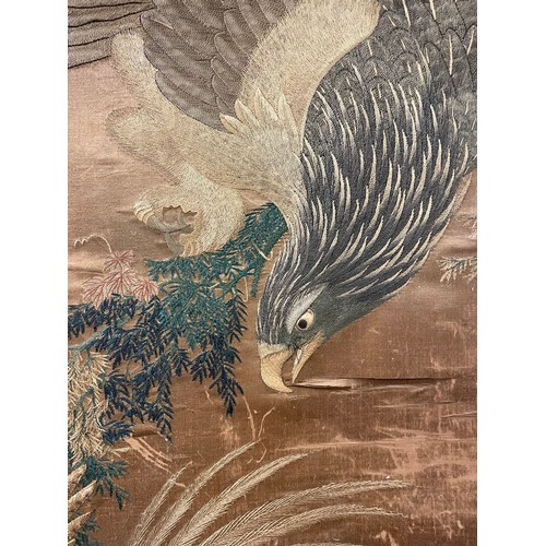 25 - A 19th century Chinese silkwork decorated scroll depicting an eagle in pursuit of a smaller bird, su... 