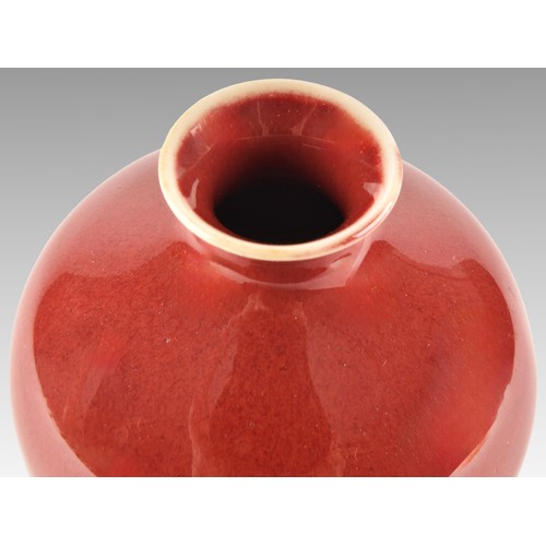 3 - A Chinese Sang de Boef vase,  of plain baluster form, with a rich red glaze, the white glaze base be... 