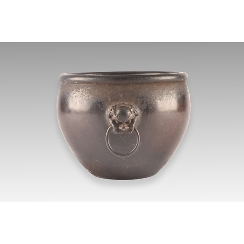 37 - An 18th century Chinese bronze bowl, with a rolled rim, dogs of foe handles, impressed Chinese chara... 