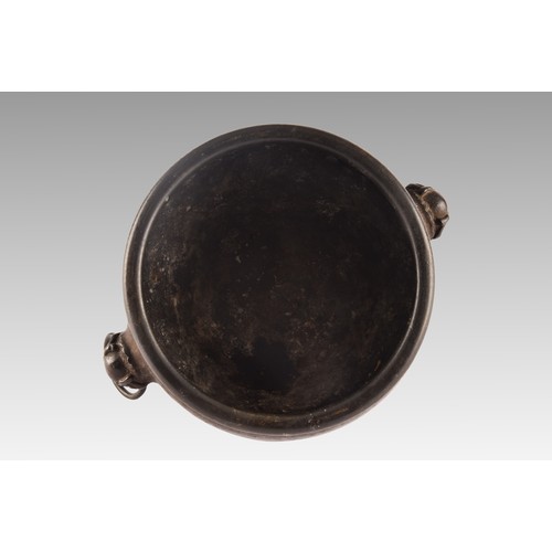 37 - An 18th century Chinese bronze bowl, with a rolled rim, dogs of foe handles, impressed Chinese chara... 