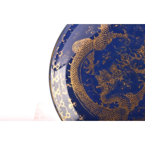 13 - A Chinese Qing Dynasty blue glaze and gilt porcelain dragon pattern dish, a pair of dragons with the... 