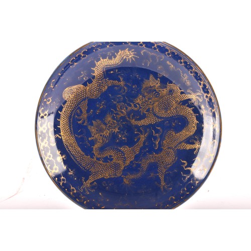 13 - A Chinese Qing Dynasty blue glaze and gilt porcelain dragon pattern dish, a pair of dragons with the... 