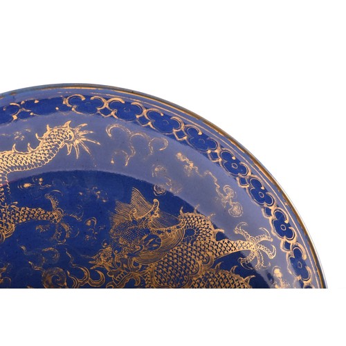 13 - A Chinese Qing Dynasty blue glaze and gilt porcelain dragon pattern dish, a pair of dragons with the... 