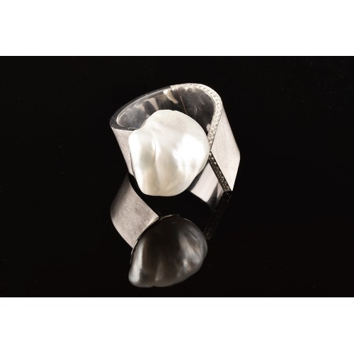 96 - A 18ct white gold ring, featuring a baroque pearl measuring approximately 1.8 x 2cm, further adorned... 