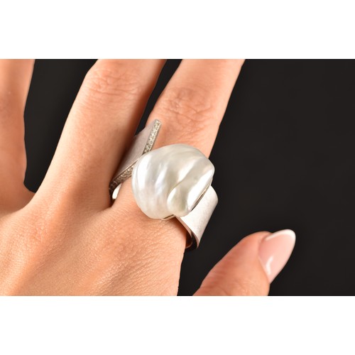 96 - A 18ct white gold ring, featuring a baroque pearl measuring approximately 1.8 x 2cm, further adorned... 