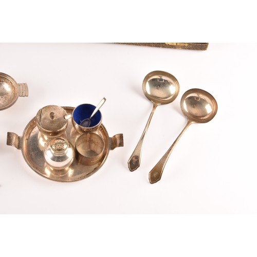 184 - A group of silver items to include two condiment sets, two ladles, a tea strainer, a trinket box, a ... 