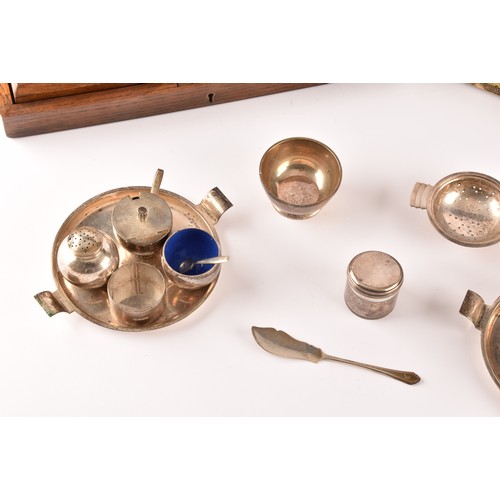 184 - A group of silver items to include two condiment sets, two ladles, a tea strainer, a trinket box, a ... 