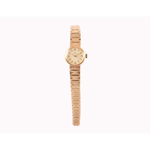 167 - A ladies Omega 9ct yellow gold wristwatch, the silvered dial with gilt numerals and baton indices, w... 