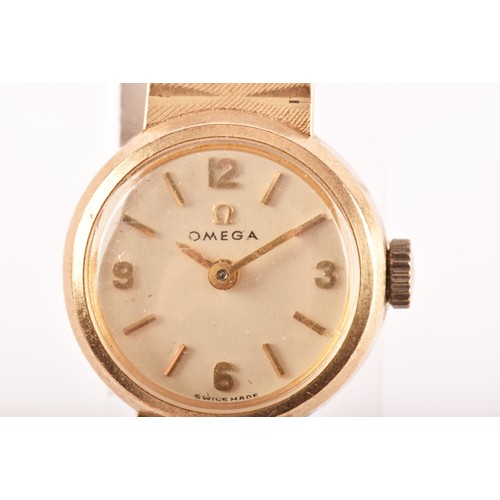 167 - A ladies Omega 9ct yellow gold wristwatch, the silvered dial with gilt numerals and baton indices, w... 