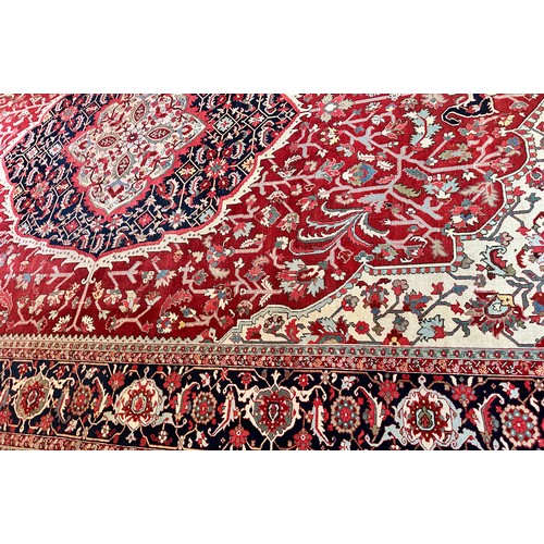 281 - A very large Persian Tabriz wool carpet featuring a large central medallion with detailed floral pat... 