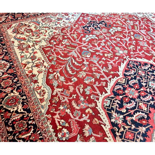 281 - A very large Persian Tabriz wool carpet featuring a large central medallion with detailed floral pat... 