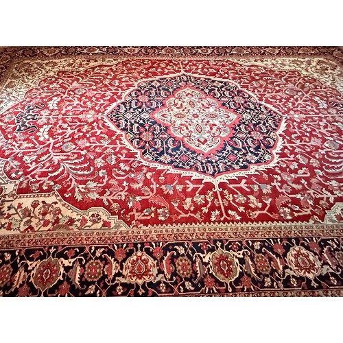 281 - A very large Persian Tabriz wool carpet featuring a large central medallion with detailed floral pat... 