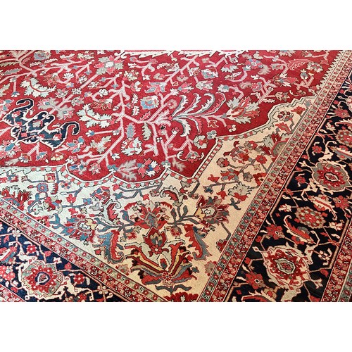 281 - A very large Persian Tabriz wool carpet featuring a large central medallion with detailed floral pat... 