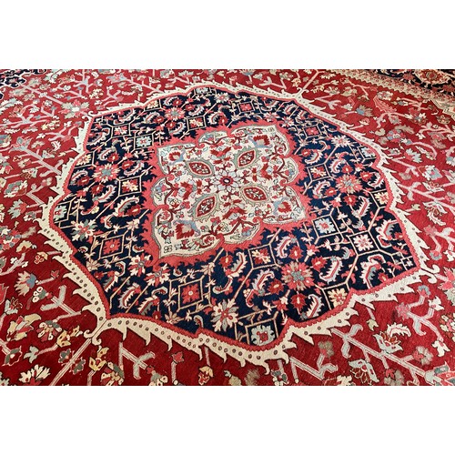 281 - A very large Persian Tabriz wool carpet featuring a large central medallion with detailed floral pat... 