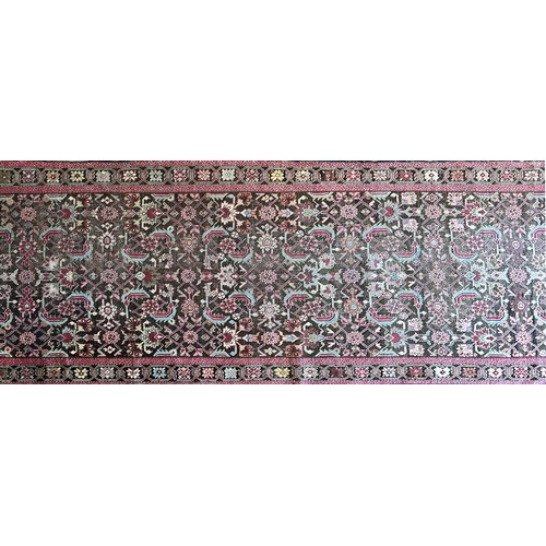 282 - A Persian Heriz handwoven long wool runner featuring geometric floral motifs throughout. The main fi... 