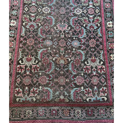 282 - A Persian Heriz handwoven long wool runner featuring geometric floral motifs throughout. The main fi... 