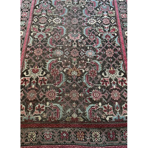 282 - A Persian Heriz handwoven long wool runner featuring geometric floral motifs throughout. The main fi... 