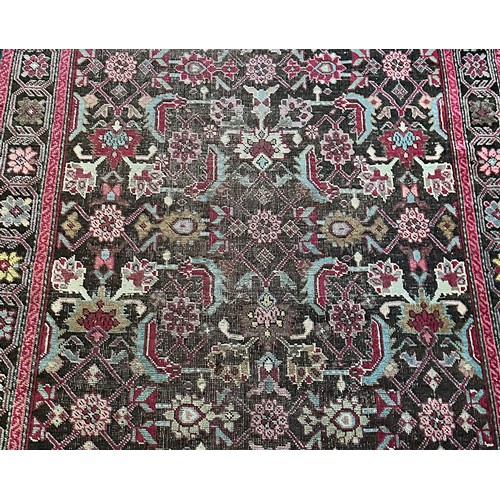 282 - A Persian Heriz handwoven long wool runner featuring geometric floral motifs throughout. The main fi... 