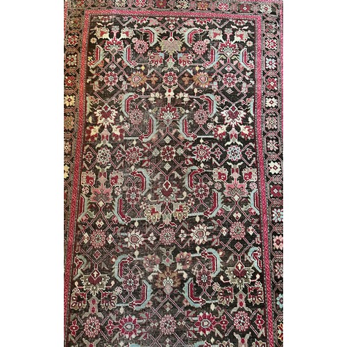 282 - A Persian Heriz handwoven long wool runner featuring geometric floral motifs throughout. The main fi... 