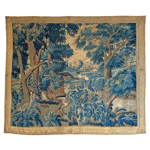 283 - A large antique European handwoven pastoral needlework tapestry depicting a woodland scene with lush... 