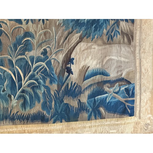 283 - A large antique European handwoven pastoral needlework tapestry depicting a woodland scene with lush... 