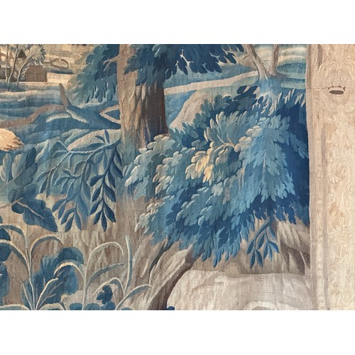 283 - A large antique European handwoven pastoral needlework tapestry depicting a woodland scene with lush... 