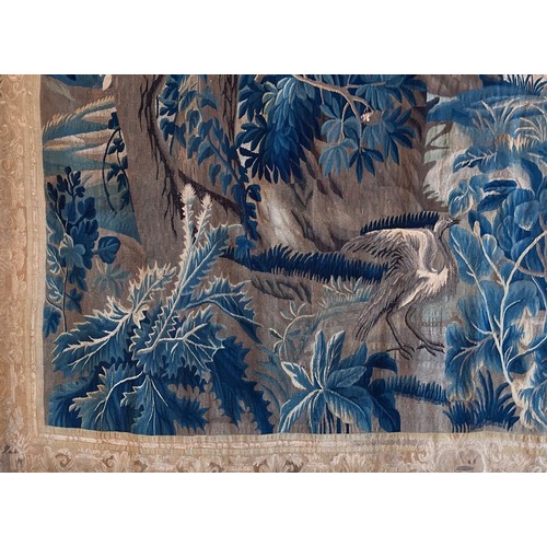 283 - A large antique European handwoven pastoral needlework tapestry depicting a woodland scene with lush... 