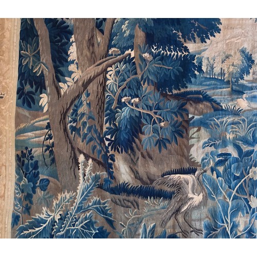 283 - A large antique European handwoven pastoral needlework tapestry depicting a woodland scene with lush... 