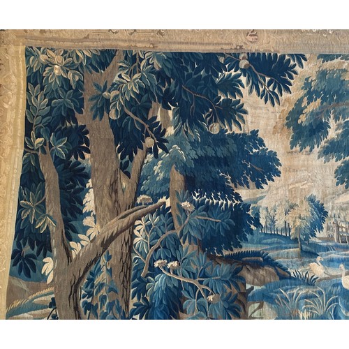 283 - A large antique European handwoven pastoral needlework tapestry depicting a woodland scene with lush... 