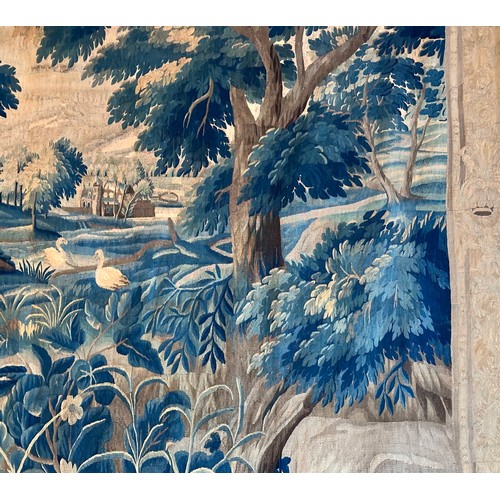 283 - A large antique European handwoven pastoral needlework tapestry depicting a woodland scene with lush... 