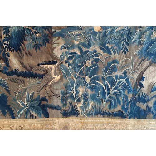 283 - A large antique European handwoven pastoral needlework tapestry depicting a woodland scene with lush... 