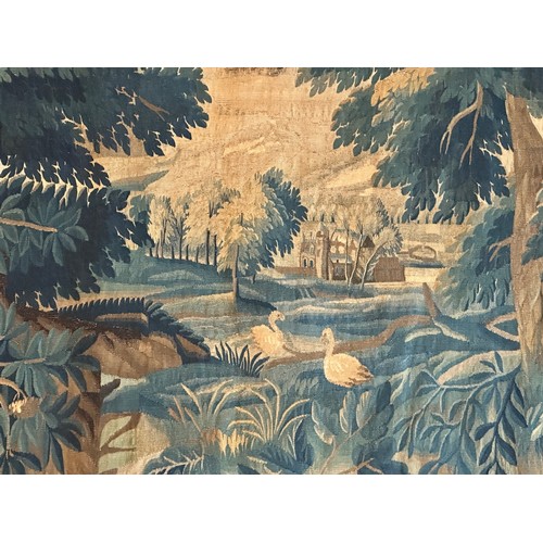 283 - A large antique European handwoven pastoral needlework tapestry depicting a woodland scene with lush... 