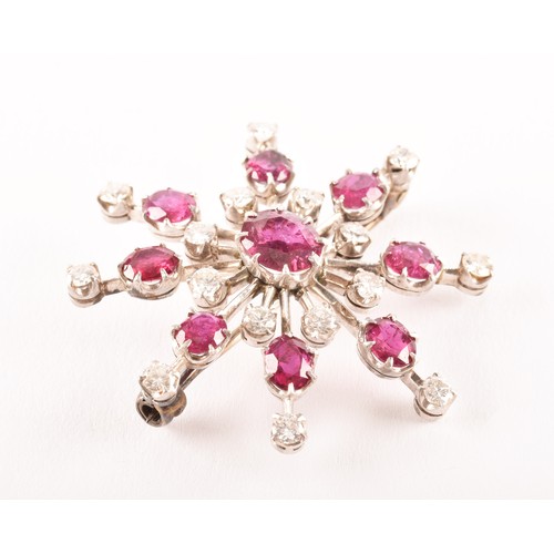 103 - An early 20th century white metal brooch featuring a oval old cut ruby to centre with an approximate... 