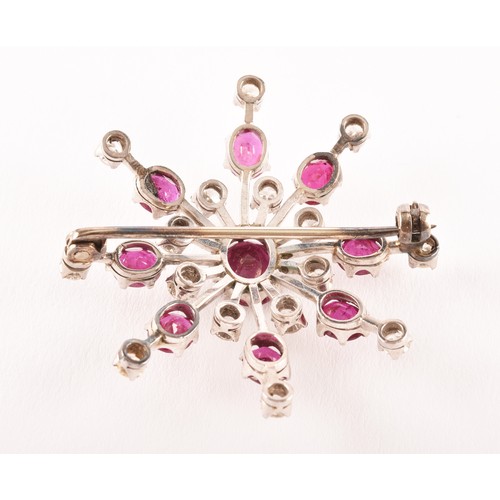 103 - An early 20th century white metal brooch featuring a oval old cut ruby to centre with an approximate... 