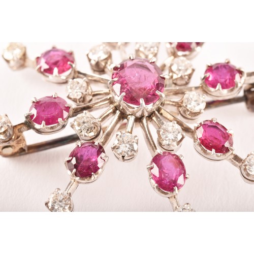 103 - An early 20th century white metal brooch featuring a oval old cut ruby to centre with an approximate... 