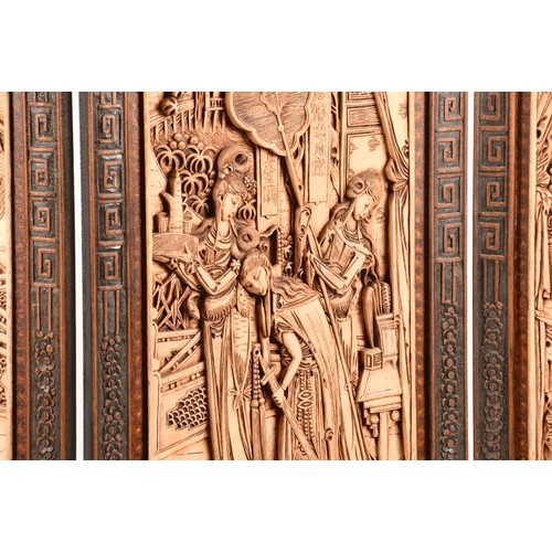 47 - A large Chinese carved wooden four fold dressing screen, elaborately carved with scenes of women in ... 