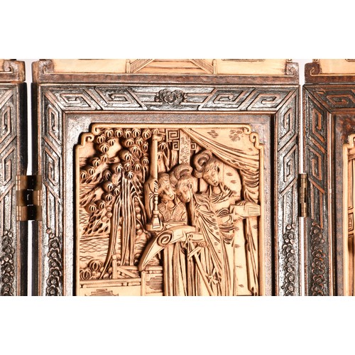 47 - A large Chinese carved wooden four fold dressing screen, elaborately carved with scenes of women in ... 