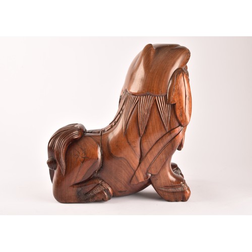 49 - A pair of early 20th century Chinese carved wooden dogs of foe, in a seated pose, with mouths agape.... 