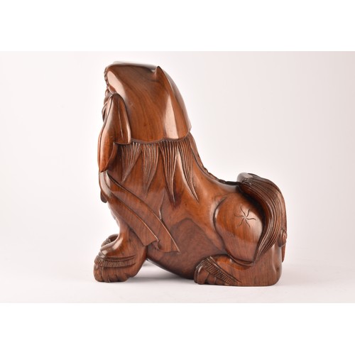 49 - A pair of early 20th century Chinese carved wooden dogs of foe, in a seated pose, with mouths agape.... 