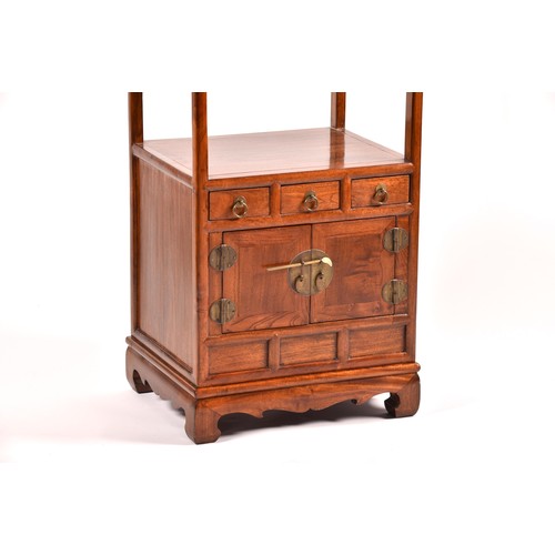 50 - A large Chinese hardwood three tier whatnot, each level inset with three small drawers, the base wit... 