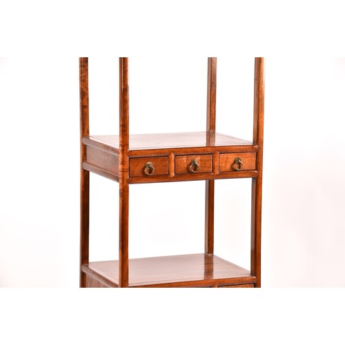 50 - A large Chinese hardwood three tier whatnot, each level inset with three small drawers, the base wit... 