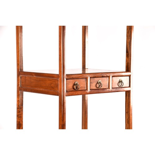 50 - A large Chinese hardwood three tier whatnot, each level inset with three small drawers, the base wit... 